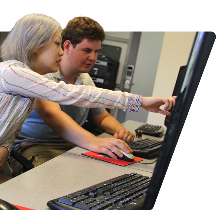 Instructor and a student collaborating at a computer
