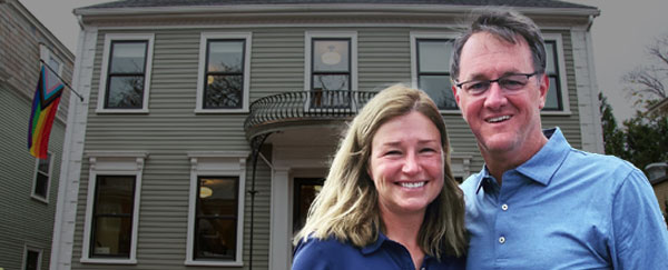 Donors Katie (left) and Brent (right) Gledhill P'21 pose in front of Stonewall House.