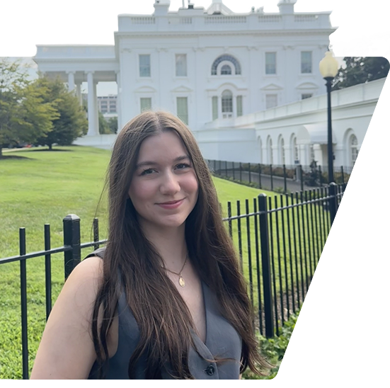 Brown student intern posing in front of the White House