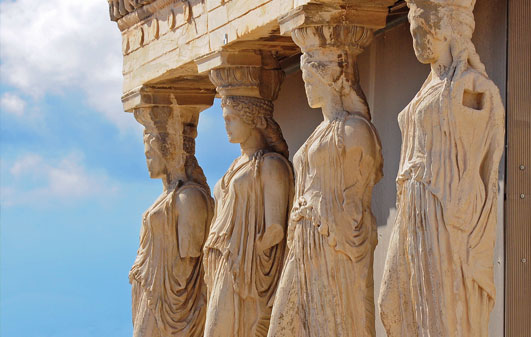 Ancient columns  of the Acropolis depicting women in robes