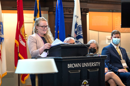 Katie Yetter speaks at a podium during Commencement Weekend.
