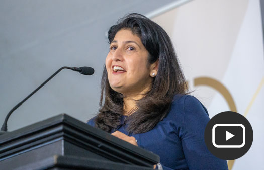 Monica Shah ’89 MD’94 speaking at podium.