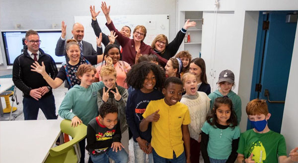 President Christina Paxson and students at the Vartan Gregorian Elementary School celebrating and smiling for camera