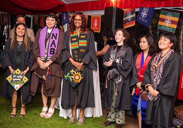 Alumni leaders posising with flags during Unity Celebration