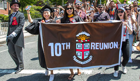 10th reunion class members marching in procession with 10th Reunion banner