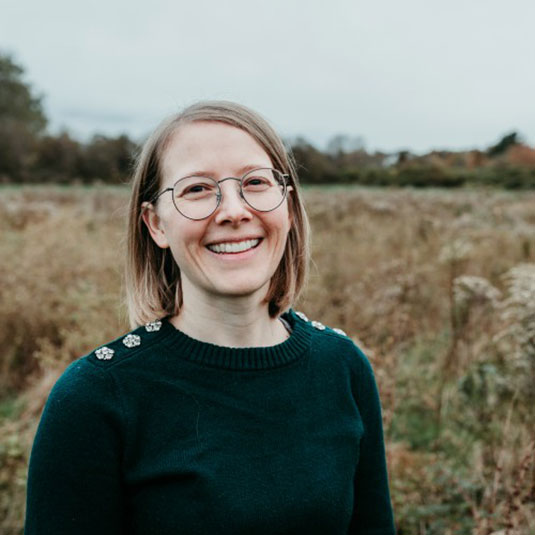 smiling Becky Scheusner outdoors in fall