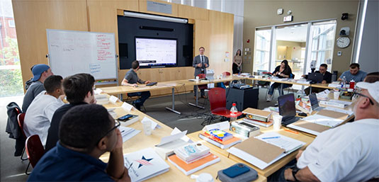 student in clssroom at Brown listening to a lecture