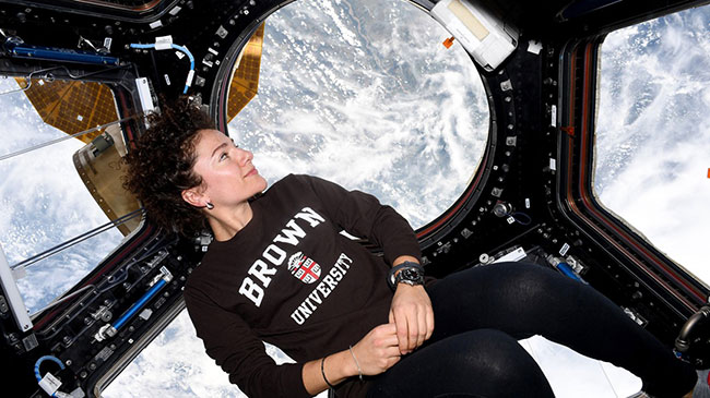 Jessica Meir in space capsule wearing Brown tshirt