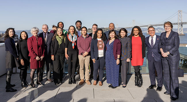 award recipients posing with President Paxson in front of the Golden Gate Bridge